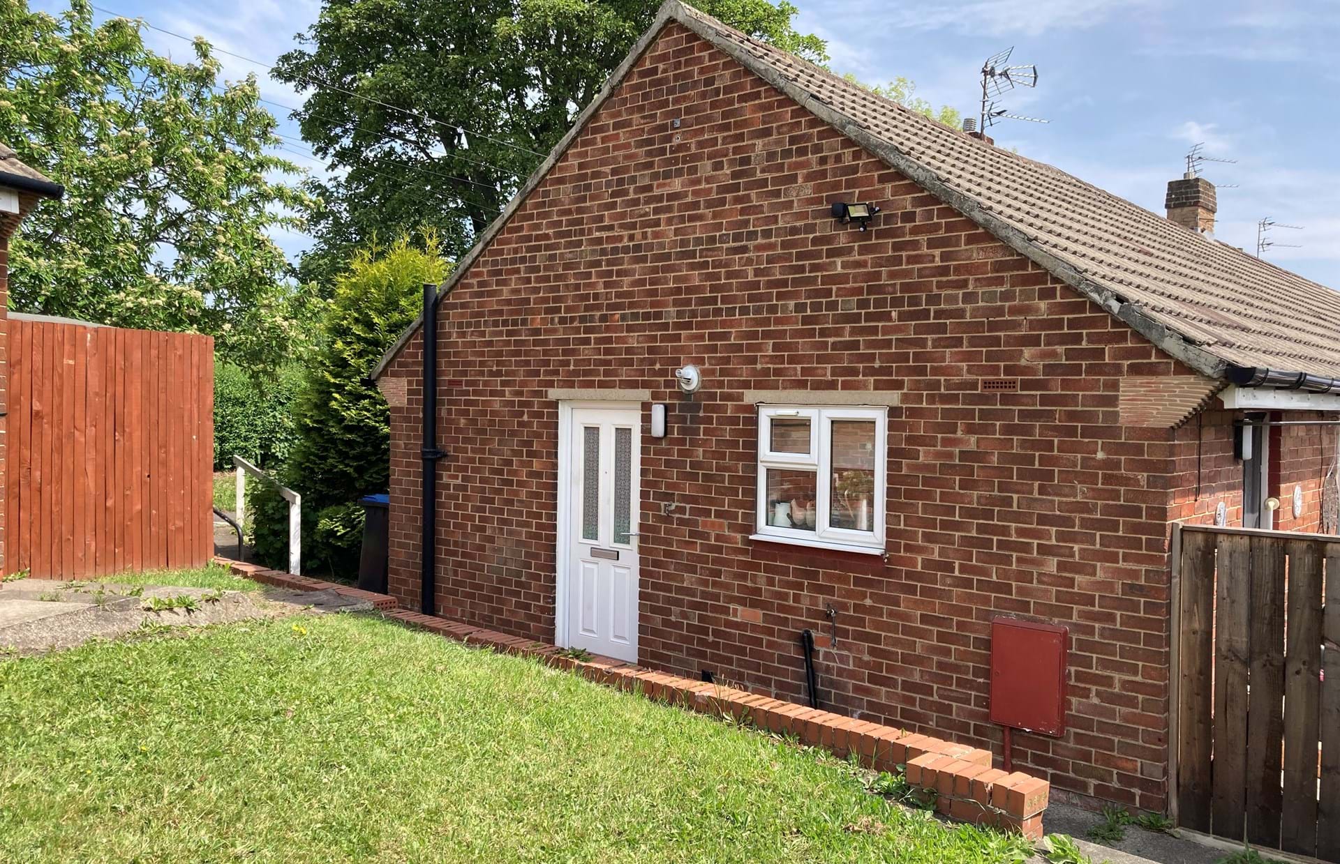 Side view of bungalow showing main door