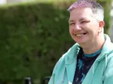 Happy tenant smiling whilst on her smartphone