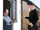 A Livin Works operative chatting to a tenant at their door